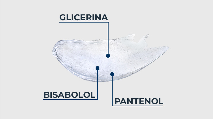 A imagem mostra uma pequena amostra translúcida do produto sobre um fundo claro. Três pontos azuis dentro da amostra estão conectados por linhas identificam os ingredientes.