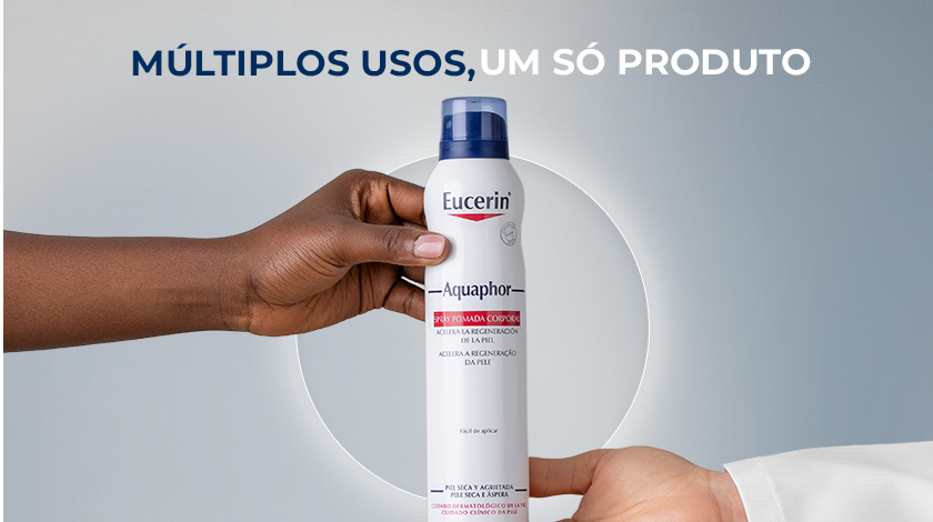 Uma mão de tom de pele retinto entrega o frasco de Eucerin Aquaphor Spray para uma mão de tom de pele claro, simbolizando o compartilhamento e a versatilidade. No topo, a frase 