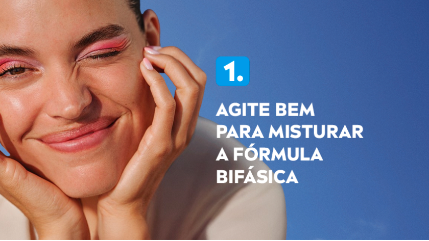 Imagem com fundo azul. Ao lado esquerdo, uma mulher aparece sorrindo com as mãos no rosto.