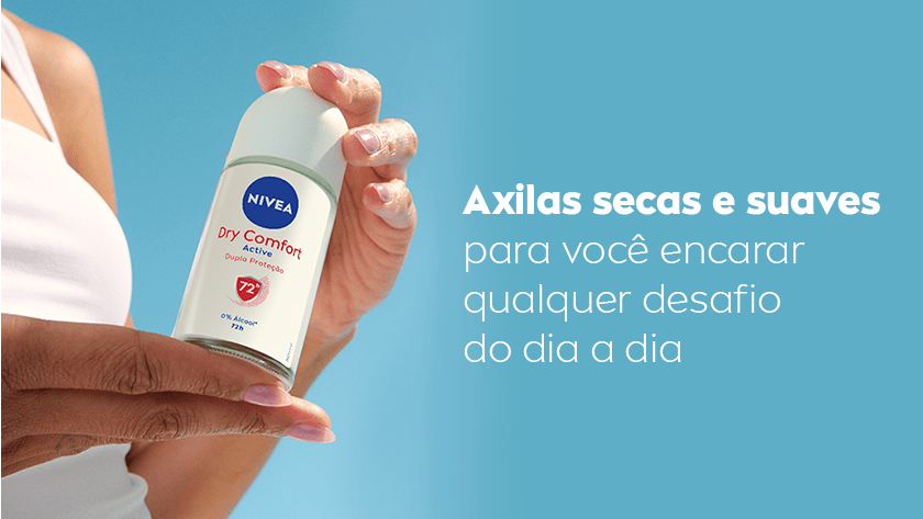Fundo azul claro em degradê. À esquerda, uma mulher veste regata branca e segura o desodorante NIVEA Dry Comfort Active Roll-on com as duas mãos. A embalagem é branca com detalhes em vermelho e azul.